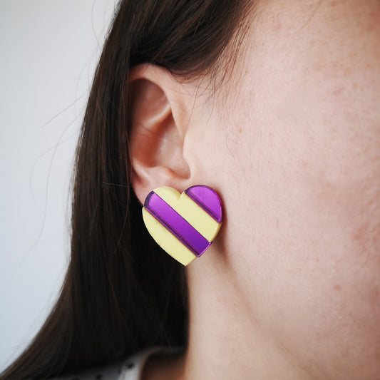 Close up striped heart earring purple mirror and butter yellow