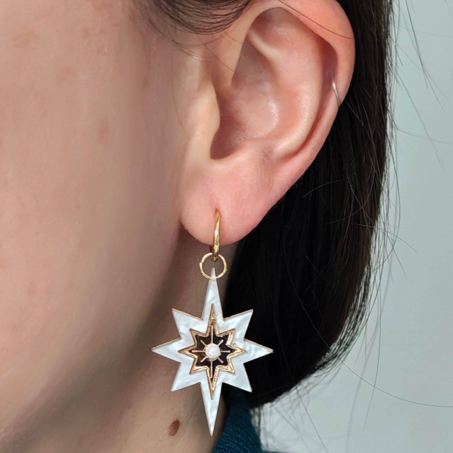 Long star shaped charms gold marble white hoops wearing on