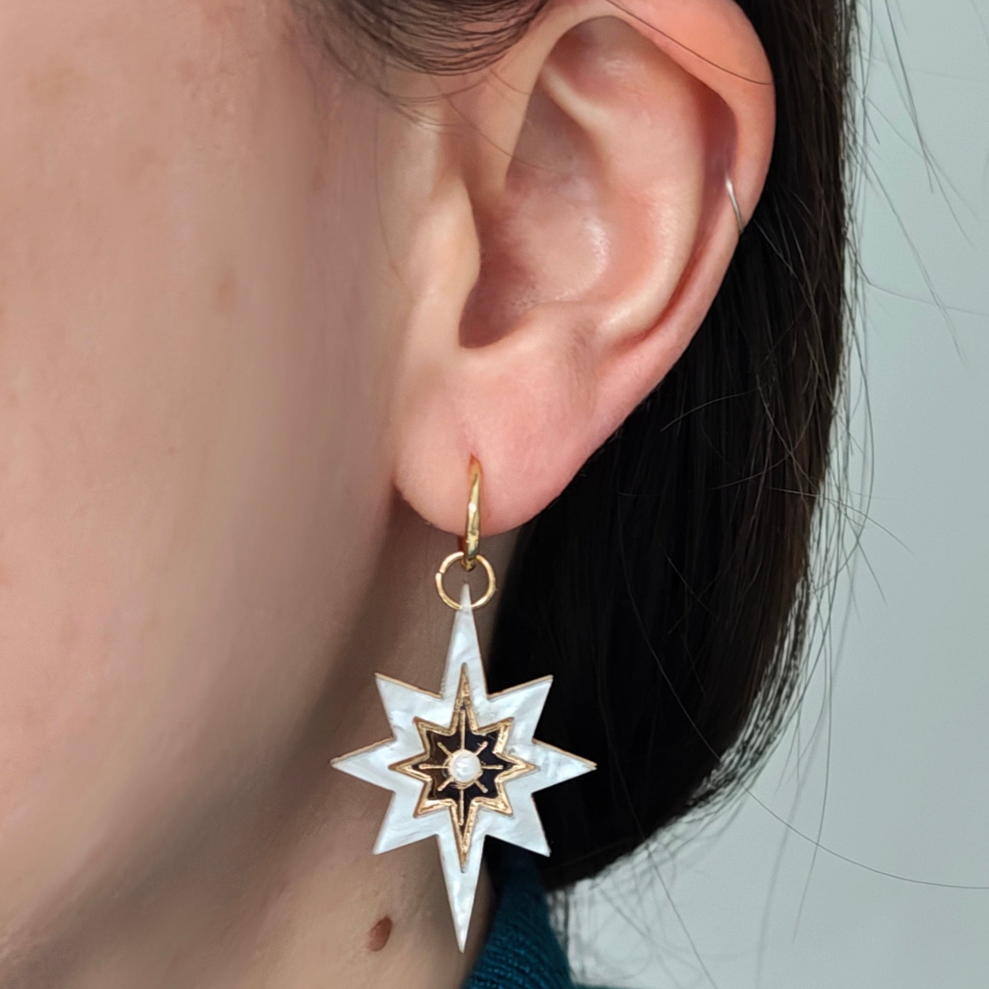 Long star shaped charms gold marble white hoops wearing on