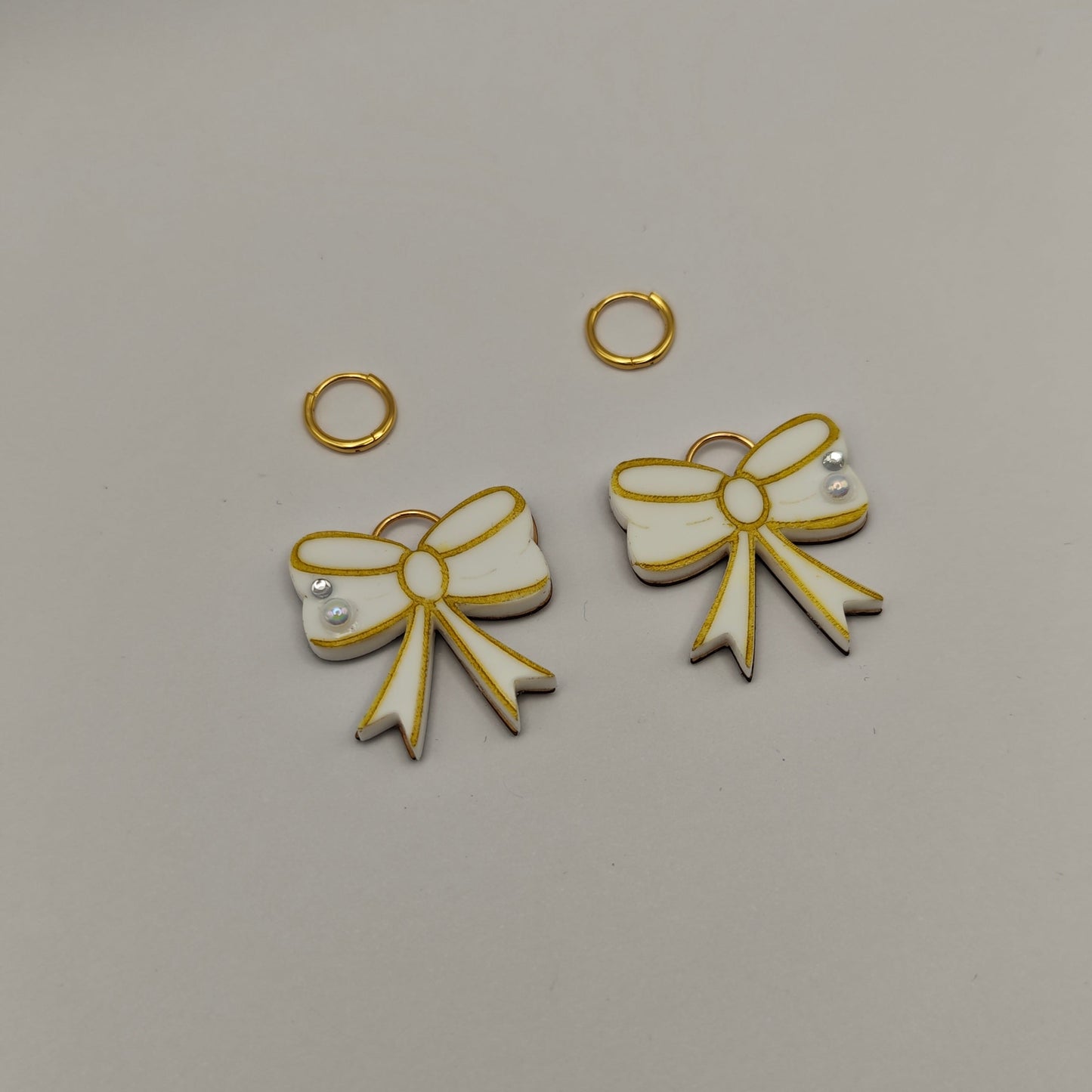 gold and white bow-shaped charms