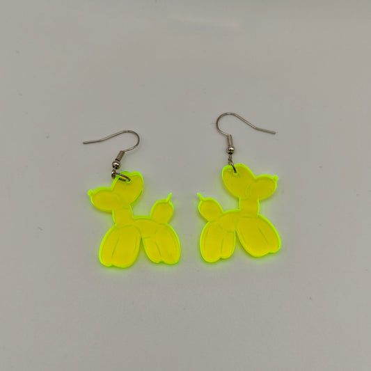 Pair of yellow balloon dog-shaped earrings on a gray background