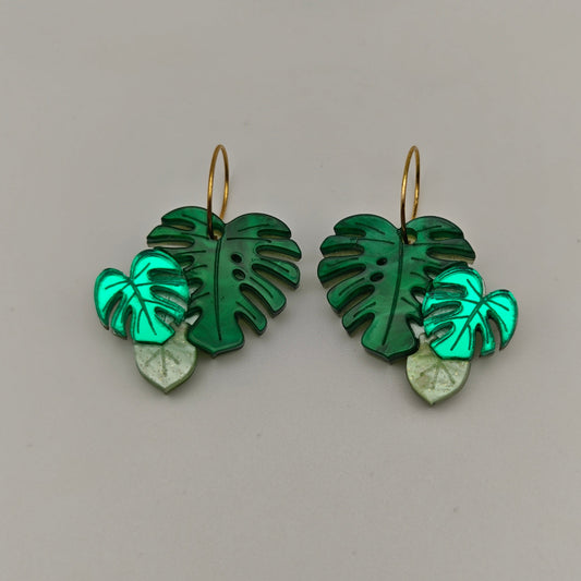 Monstera Deliciosa green leaf-shaped earrings on a gray background