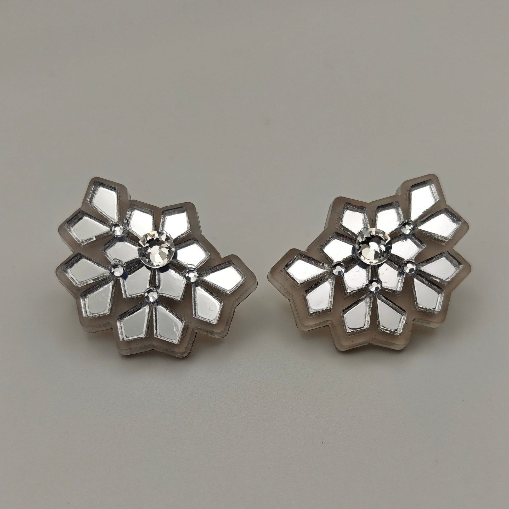 Silver acrylic stud earrings white frosted snowflake, close up picture