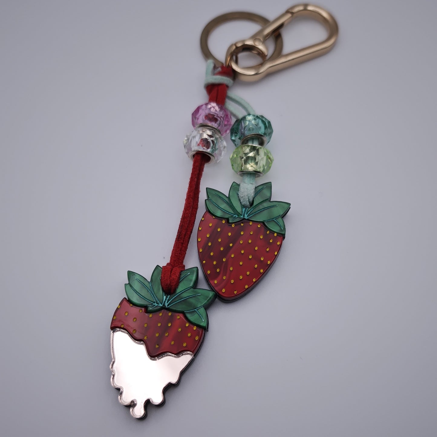 marbled red green dusty pink light acrylic playful lightweight colour beds red clear aqua green vegan leather cord golden clasp keyring strawberries cream close up
