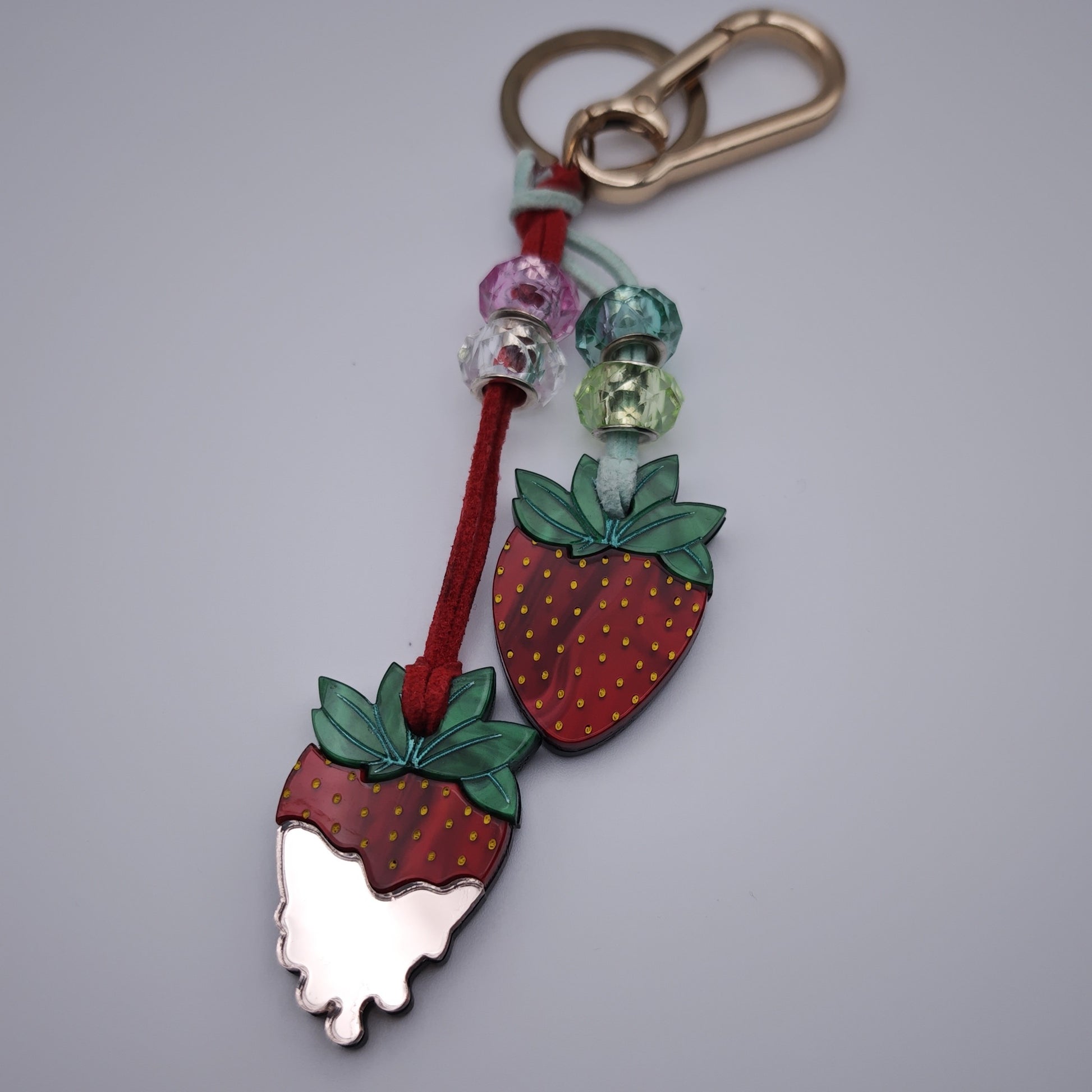 marbled red green dusty pink light acrylic playful lightweight colour beds red clear aqua green vegan leather cord golden clasp keyring strawberries cream close up